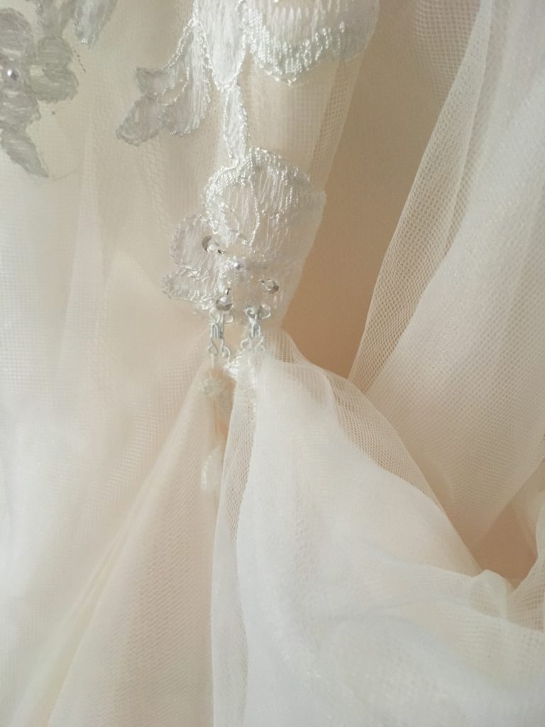 prom dress bustle What to do for a prom dress with a train? Bustle it! A bustle is simply a hook or series of hooks to lift the train off the floor for dancing and